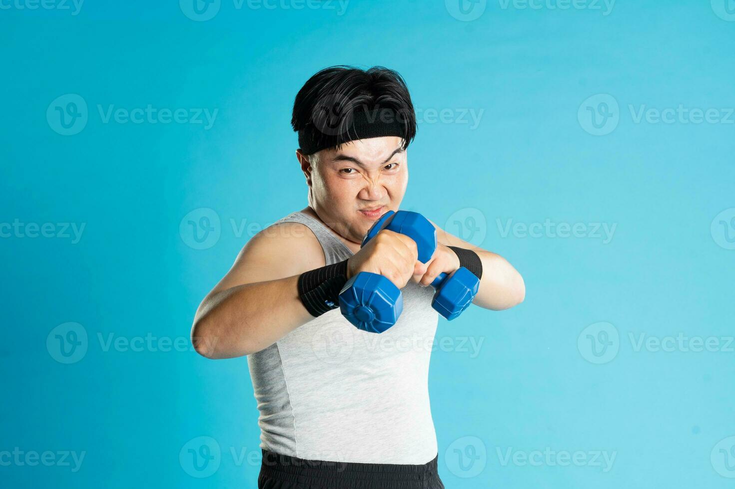 Image of Asian man exercising on blue background photo