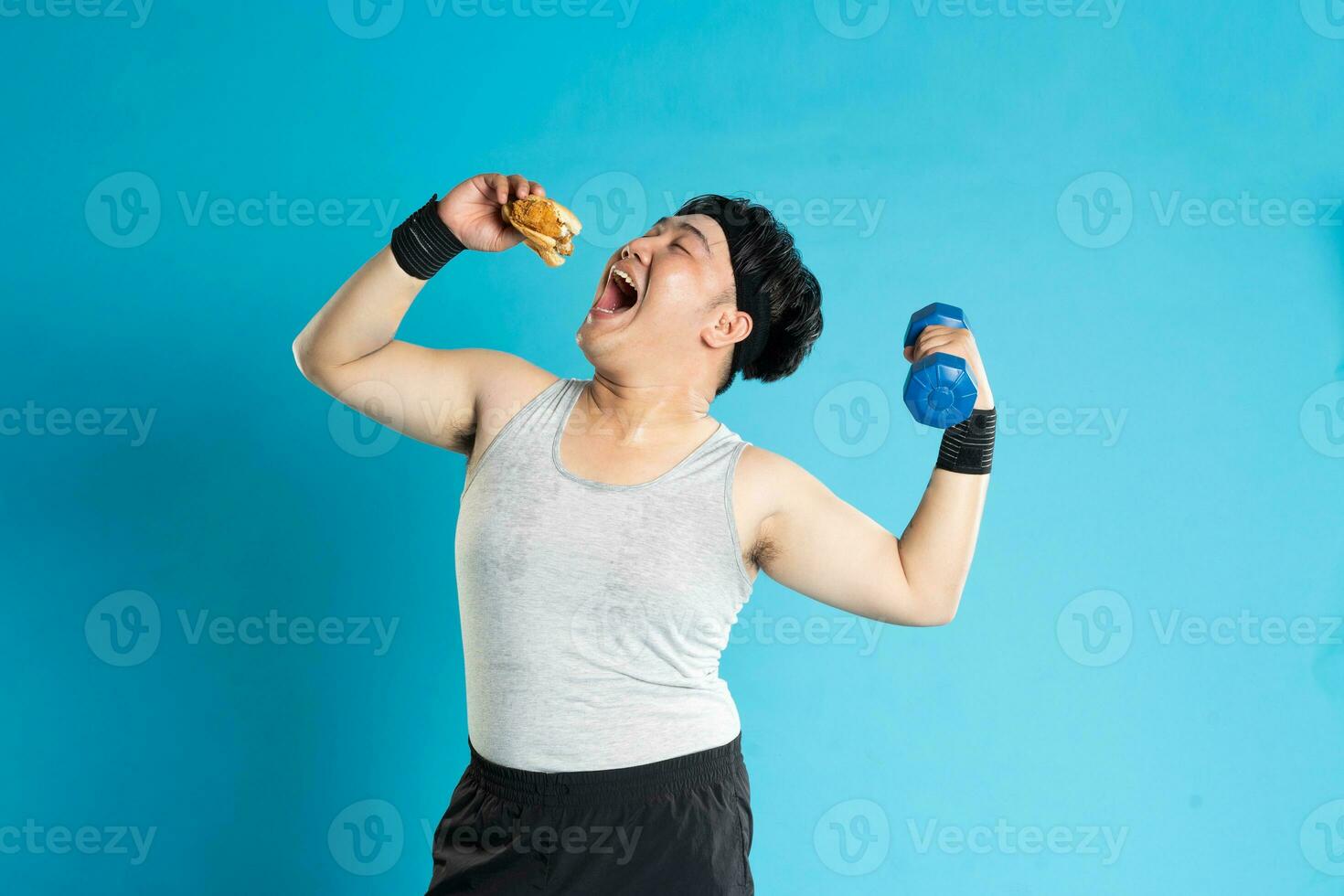 Image of Asian man exercising on blue background photo