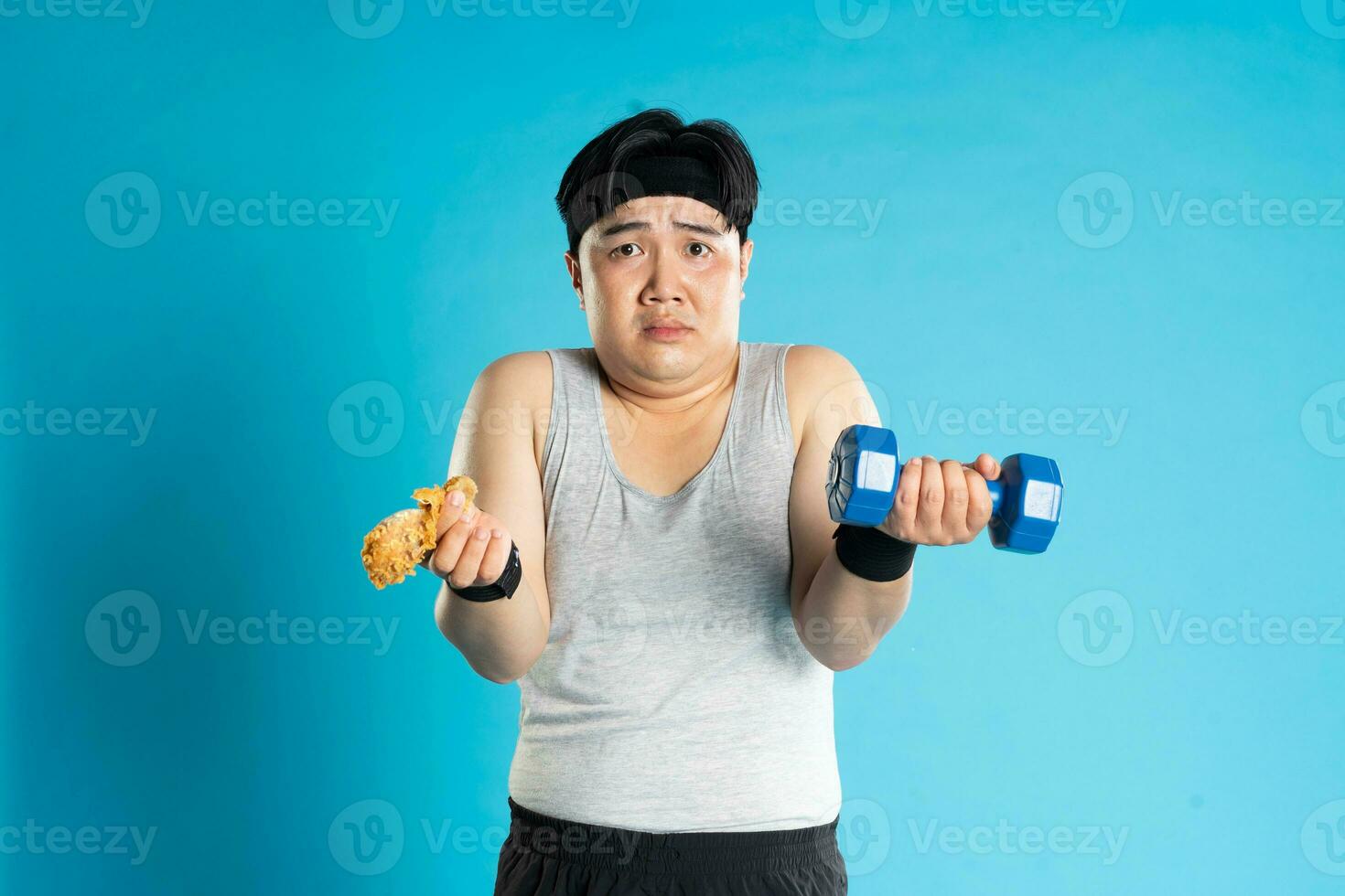 Image of Asian man exercising on blue background photo