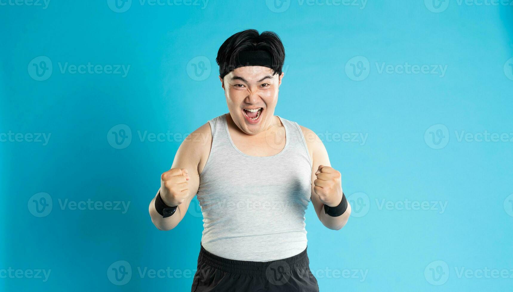 Image of Asian man exercising on blue background photo