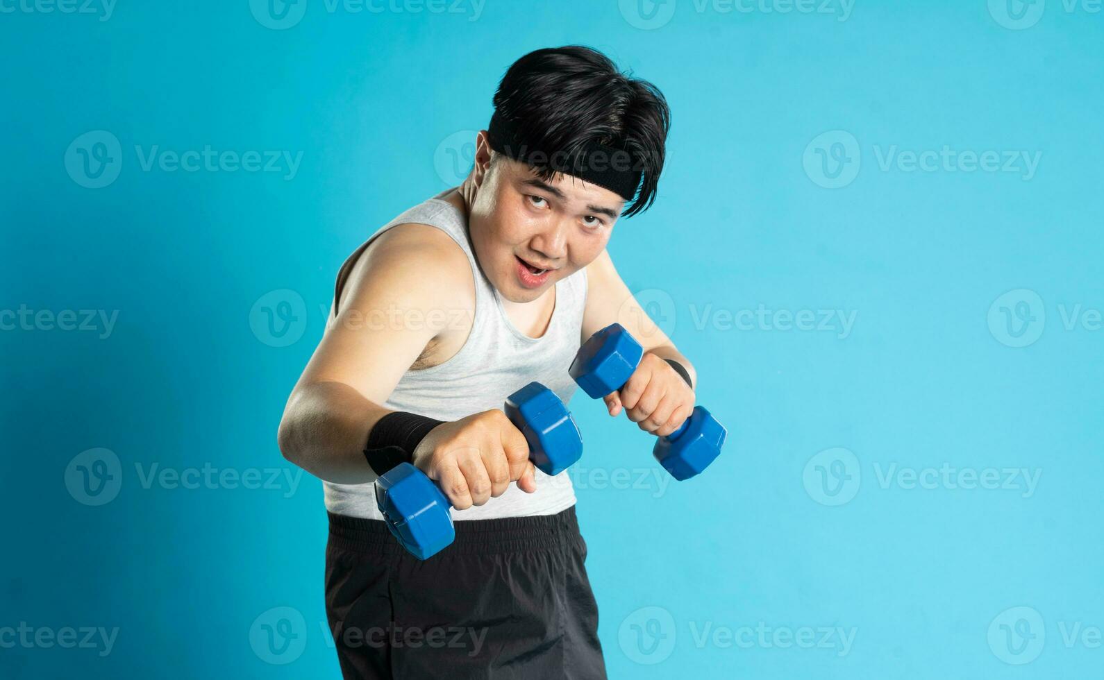 Image of Asian man exercising on blue background photo