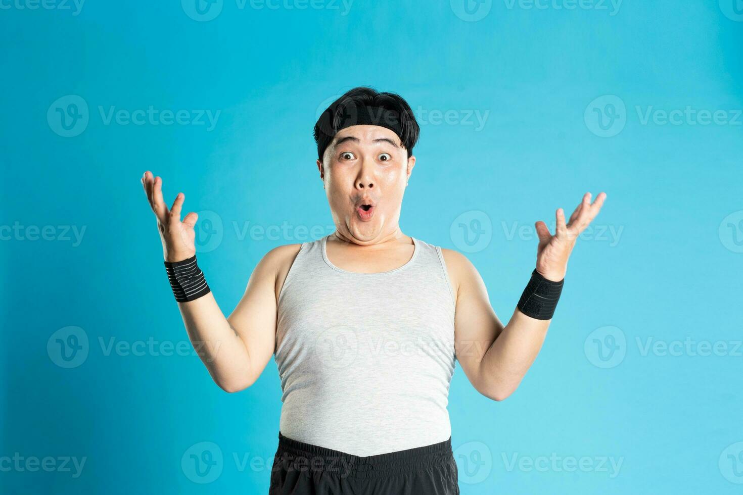 Image of Asian man exercising on blue background photo