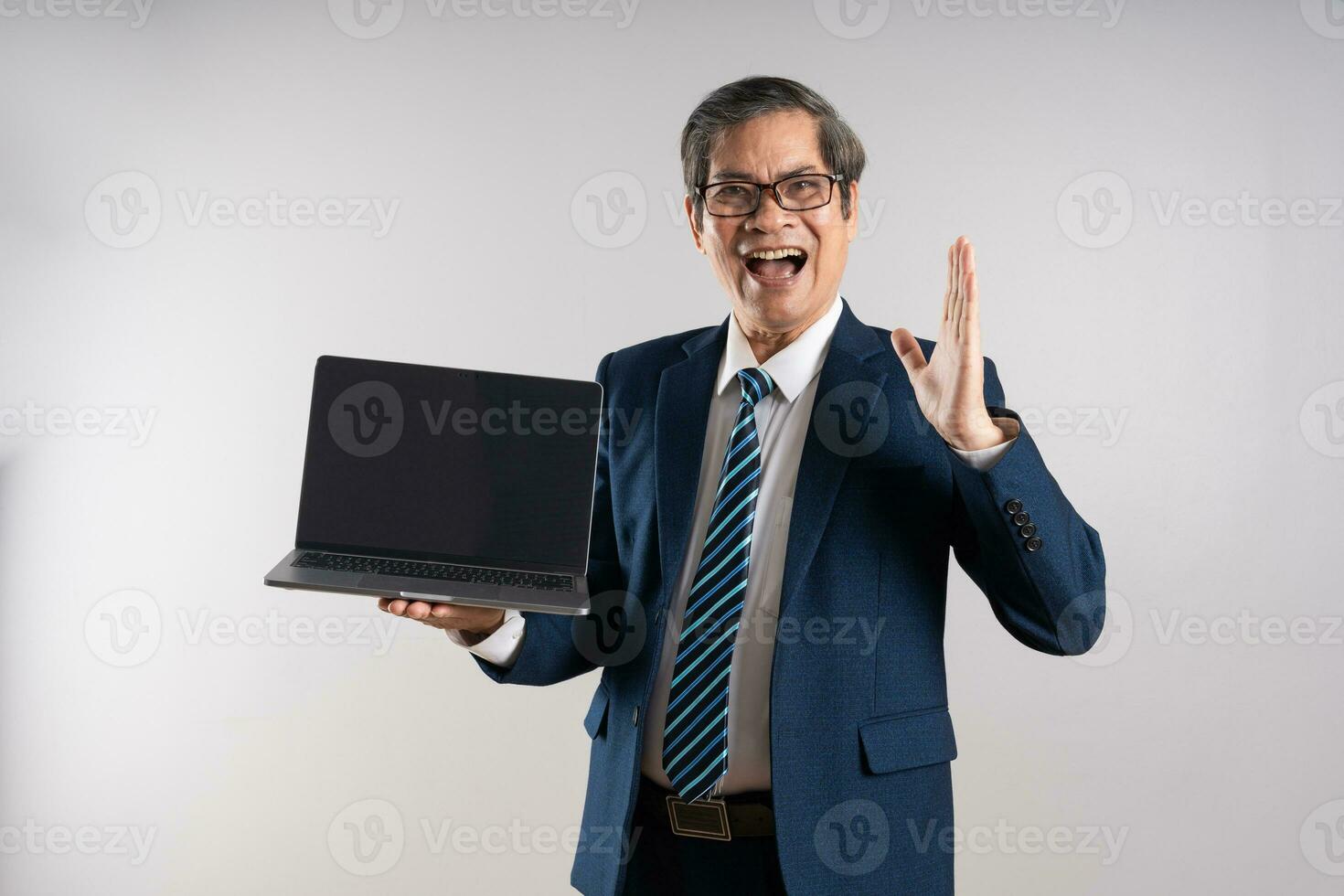 Portrait of an elderly Asian businessman, posing on a blue background photo