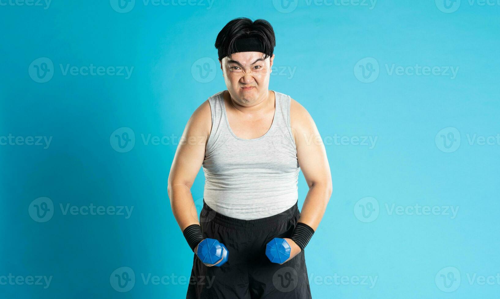 Image of Asian man exercising on blue background photo