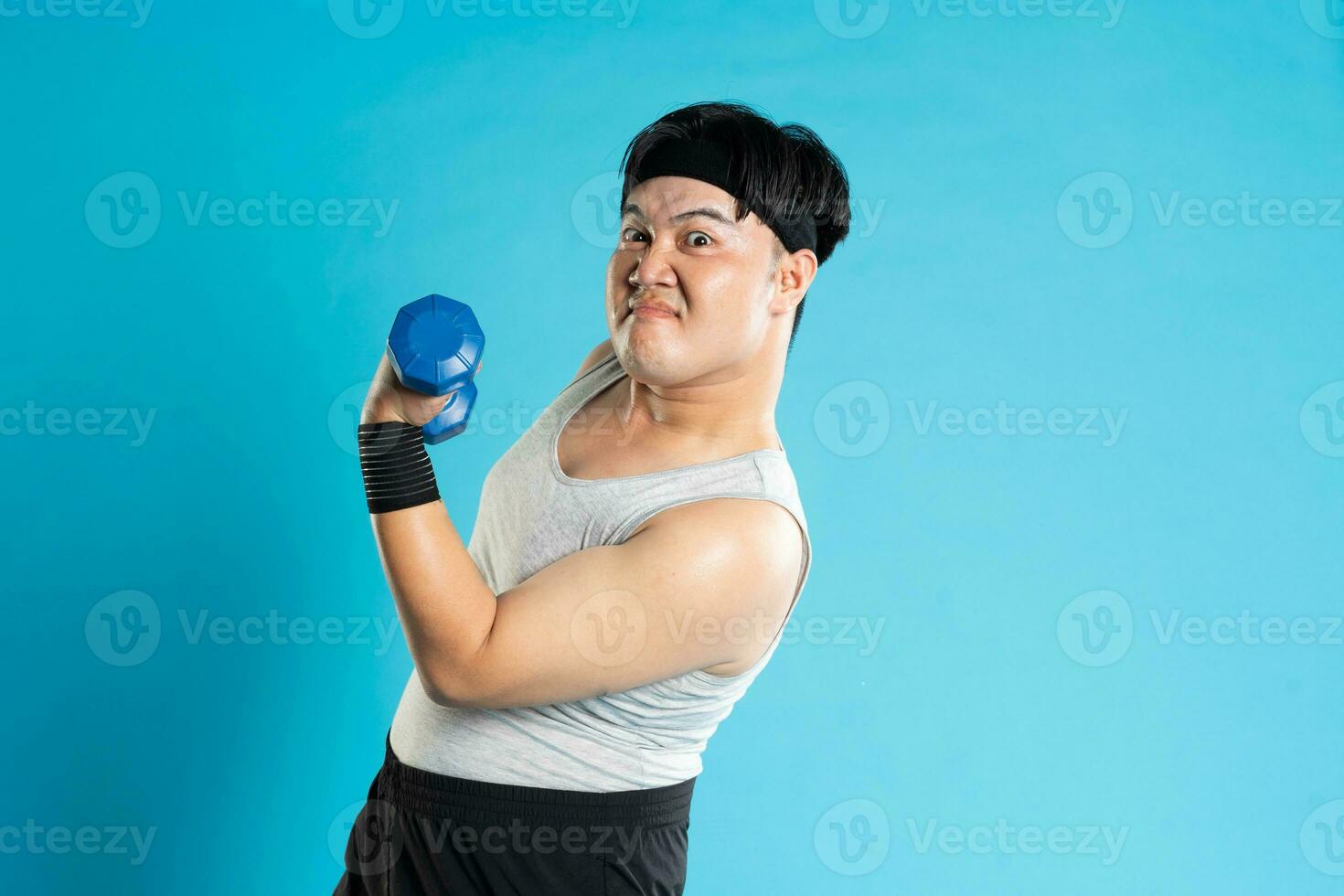 Image of Asian man exercising on blue background photo