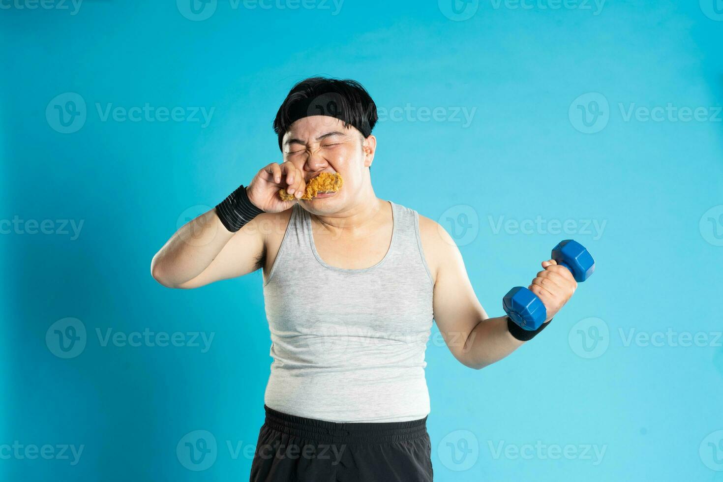 Image of Asian man exercising on blue background photo