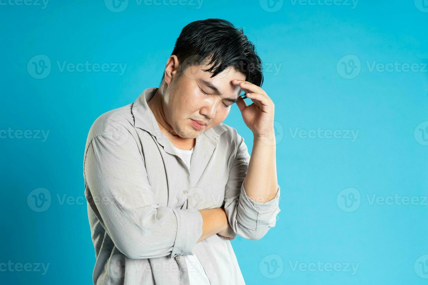 Image of Asian man having health problems, isolated on blue background photo