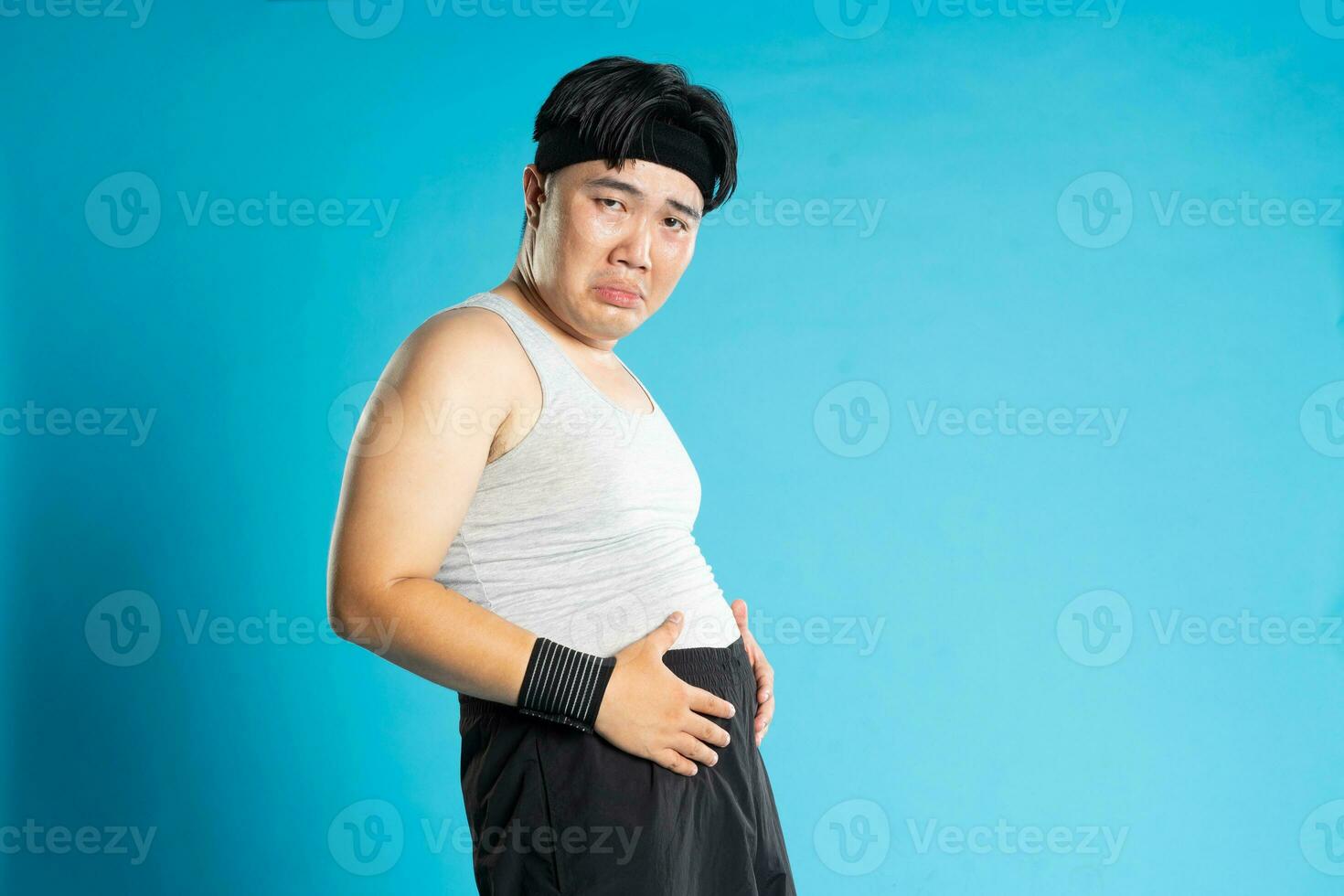 Image of Asian man exercising on blue background photo