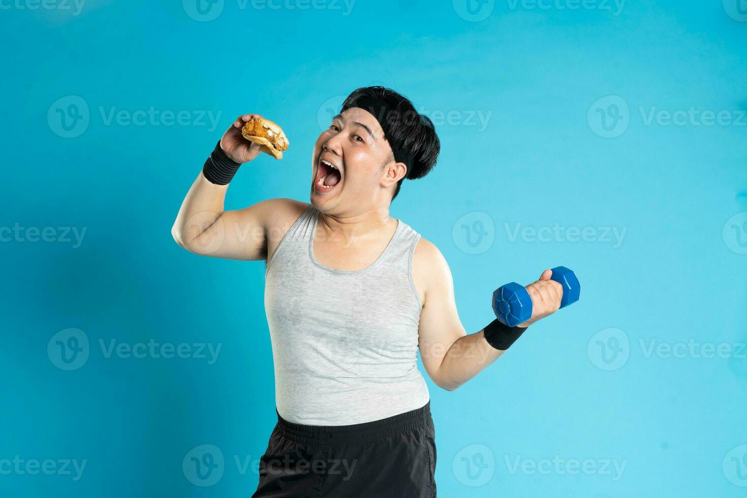 Image of Asian man exercising on blue background photo