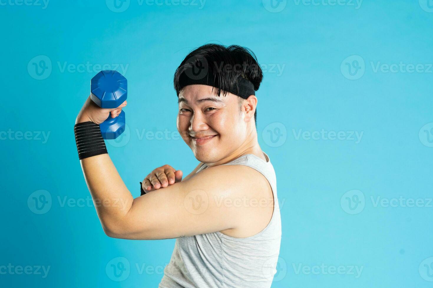 Image of Asian man exercising on blue background photo
