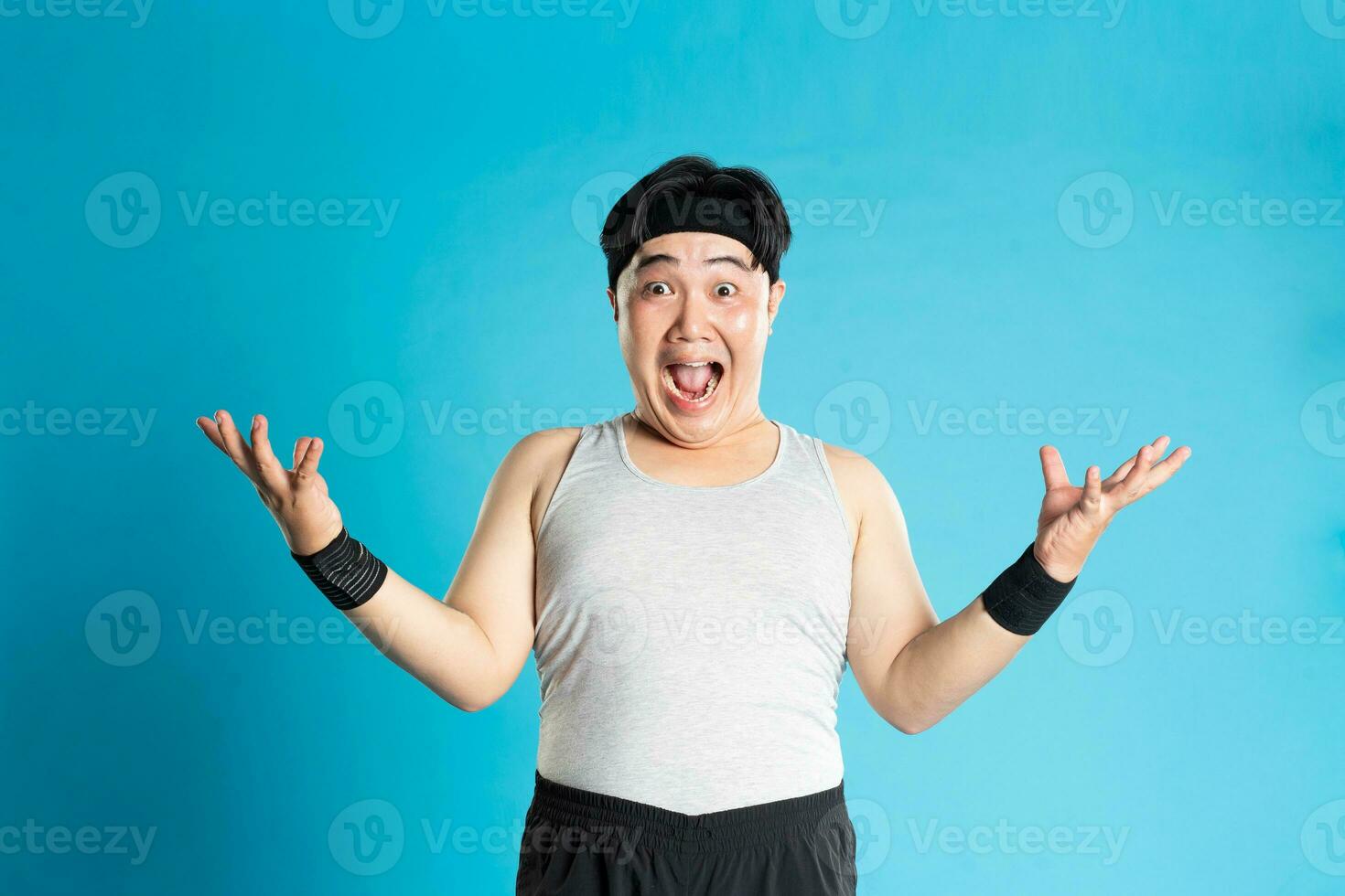 Image of Asian man exercising on blue background photo