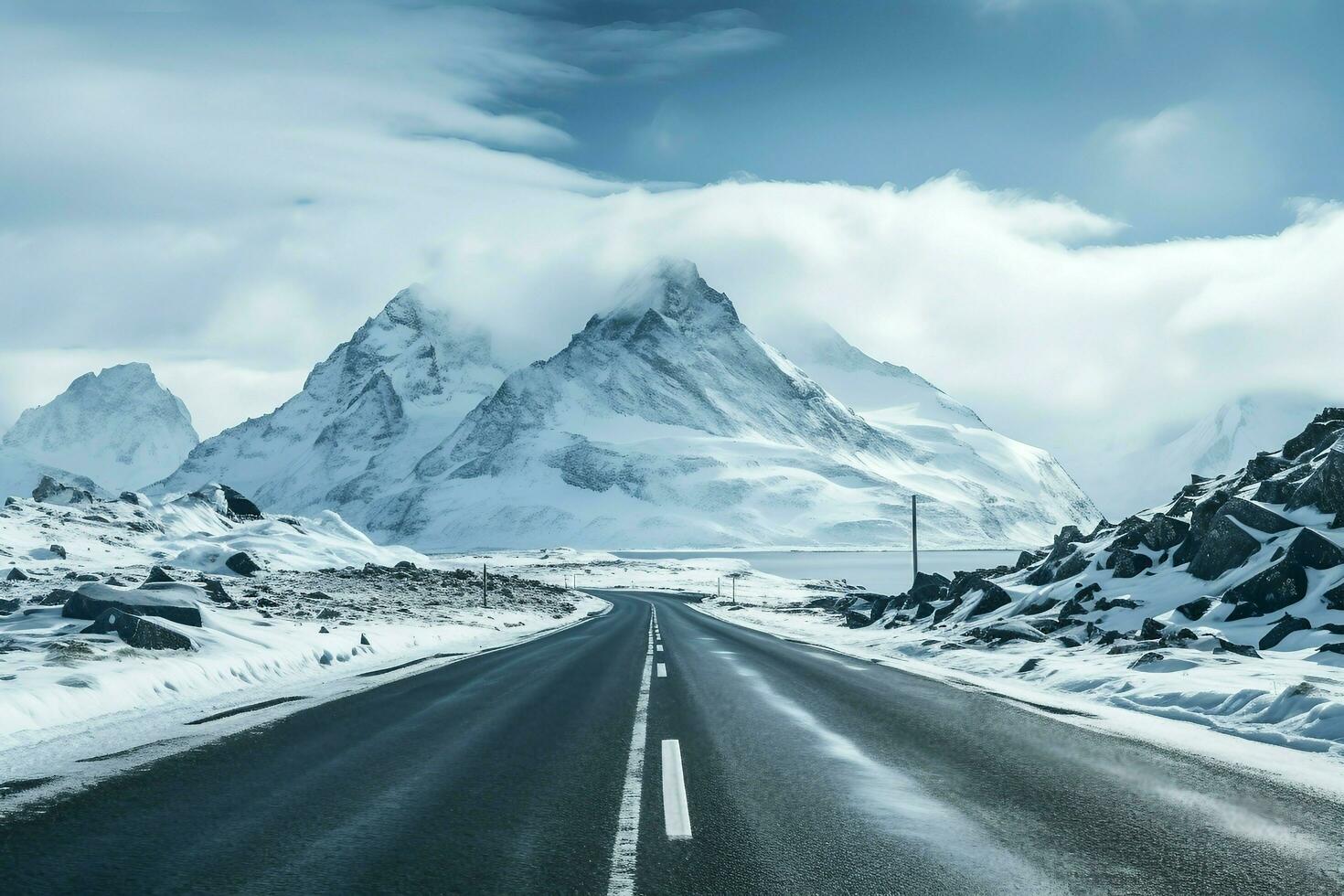 Empty road in the middle of snowy mountain range AI Generated photo