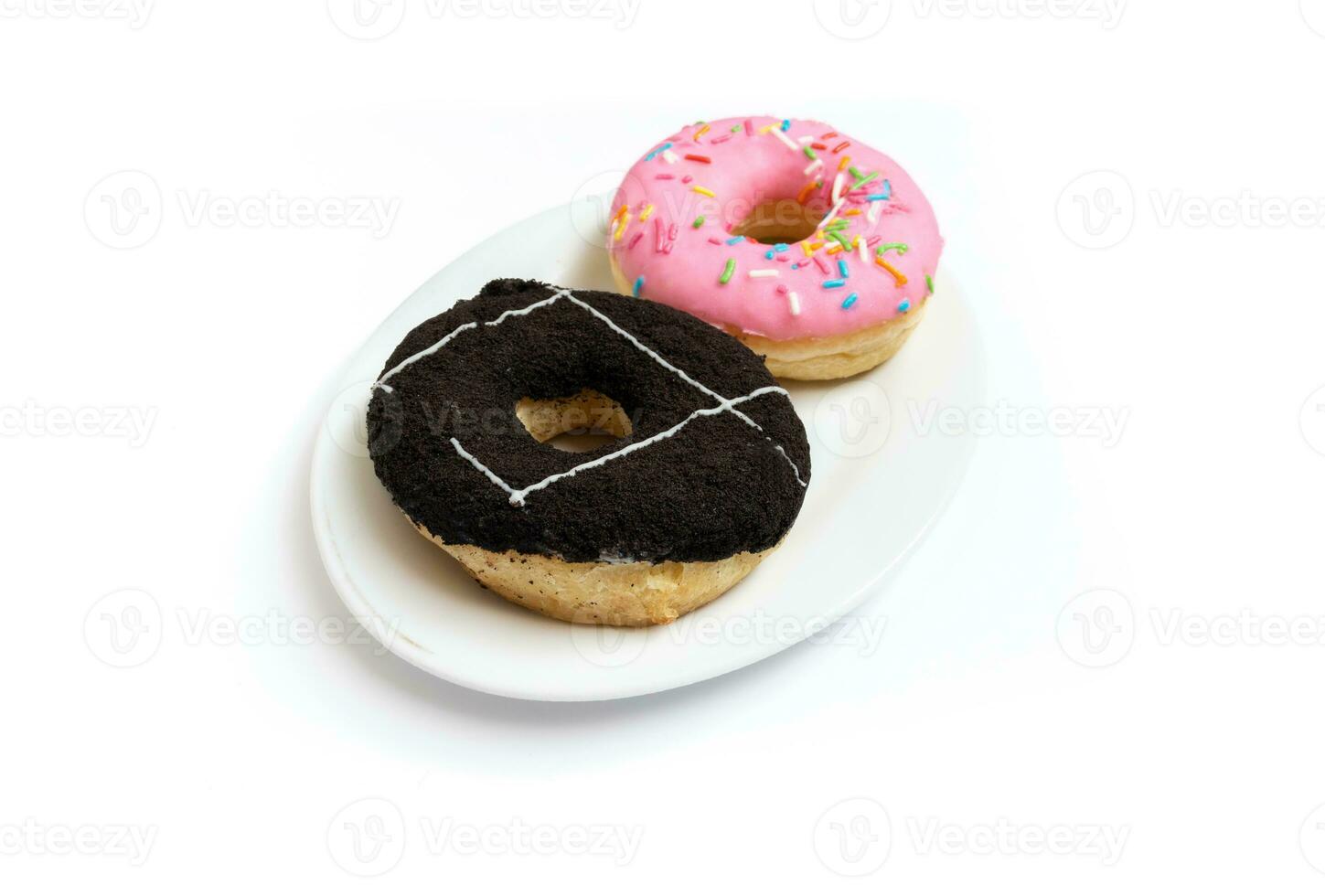 Edited photo. Messy strawberry and chocolate doughnuts on a plate isolated on white background. photo