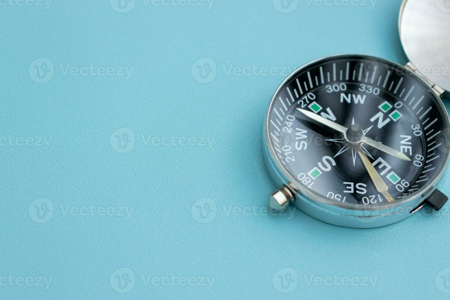 A compass isolated on blue background, after some edits. photo