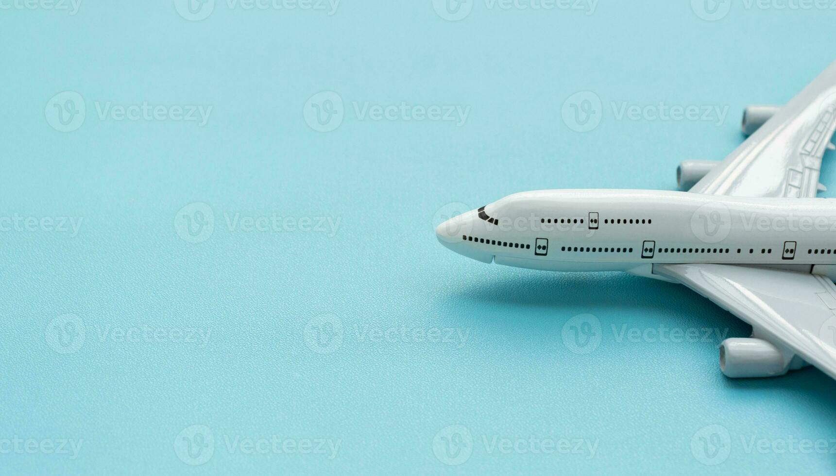 A plane miniature and isolated on blue background, after some edits. photo