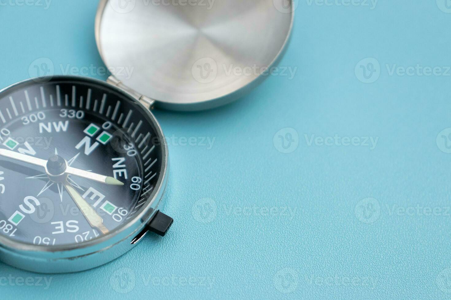 A compass isolated on blue background, after some edits. photo