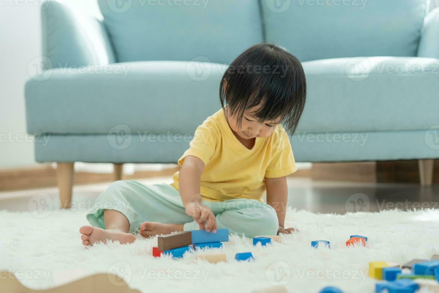 Happy Asian child playing and learning toy blocks. children are very happy and excited at home. child have a great time playing, activities, development, attention deficit hyperactivity disorder photo