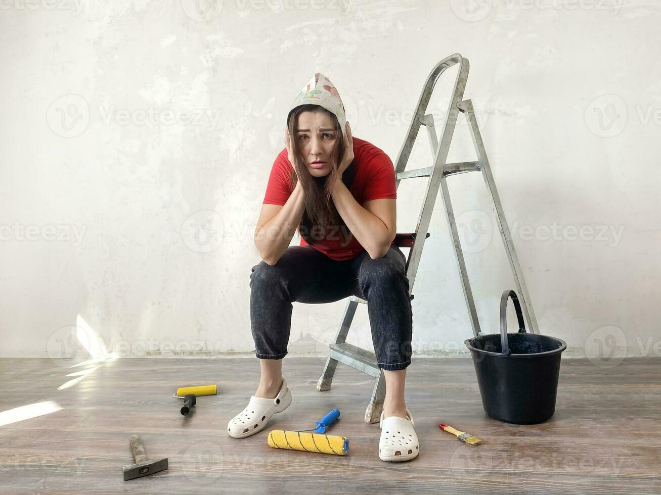 Tired, exhausted, stressed woman doing a home renovation photo