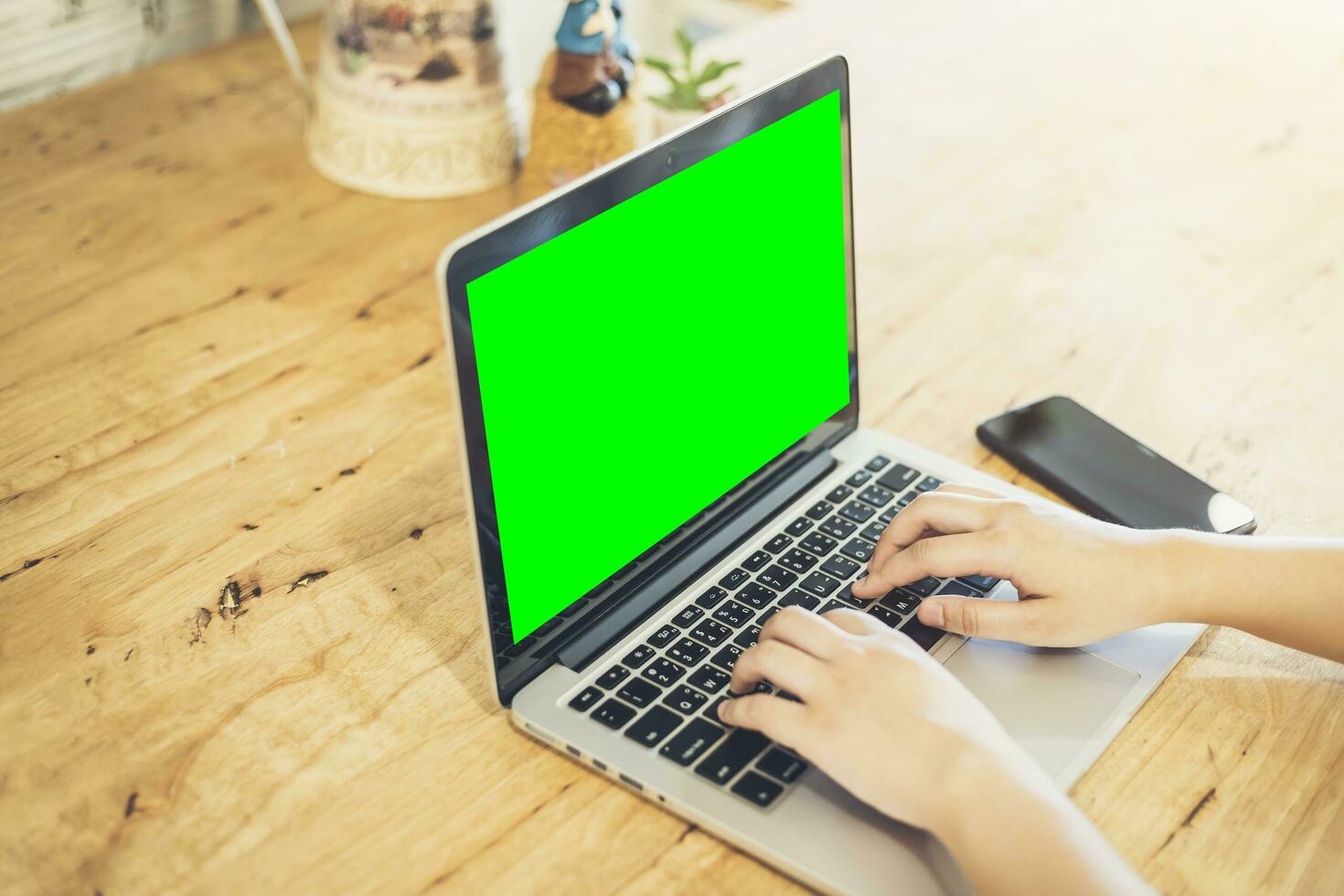 Close-up of business female working with laptop and smartphone in coffee shop like the background photo