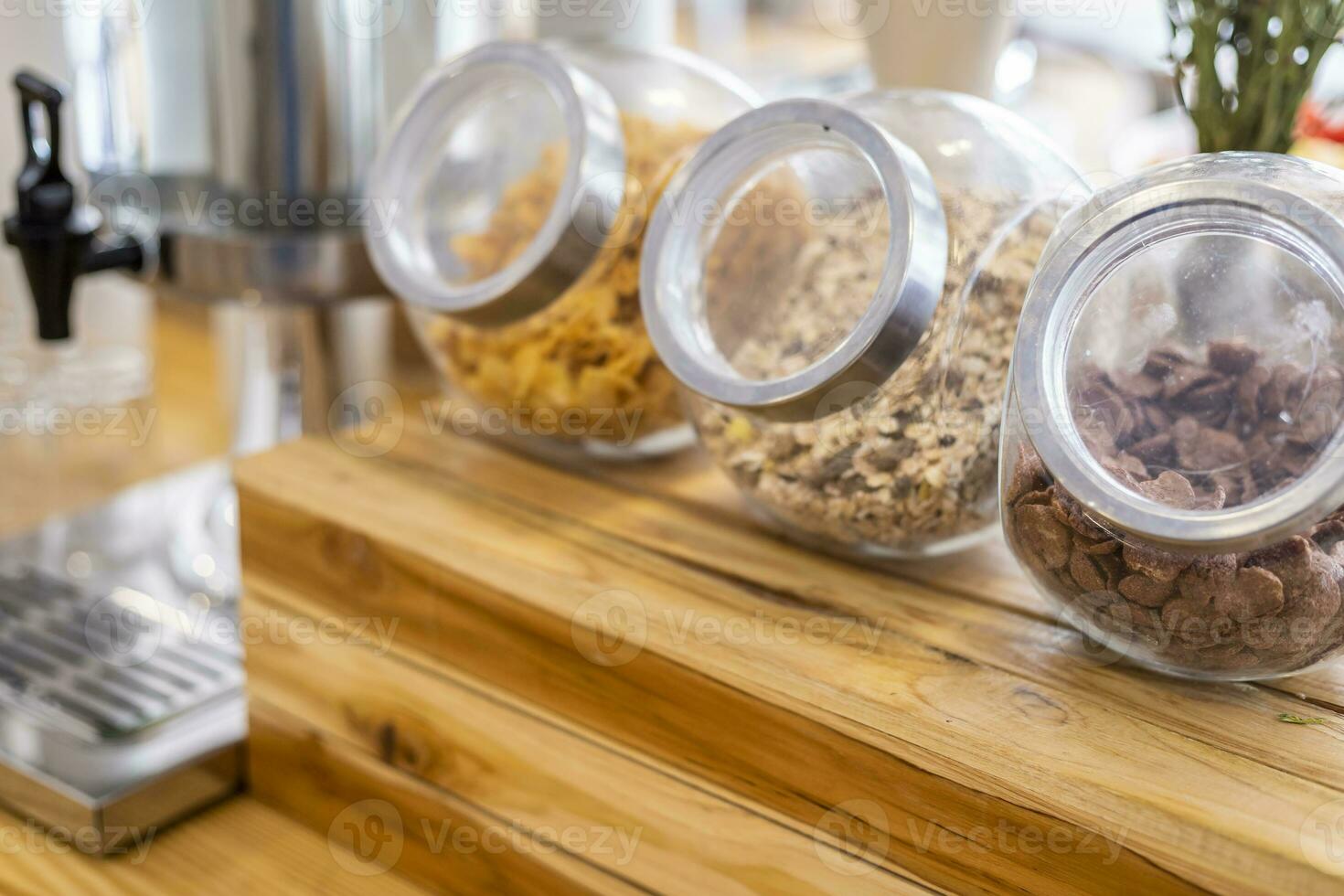 Long row Glass jars with breakfast cereal at on the dining table decoration at buffet self service at hotel. photo