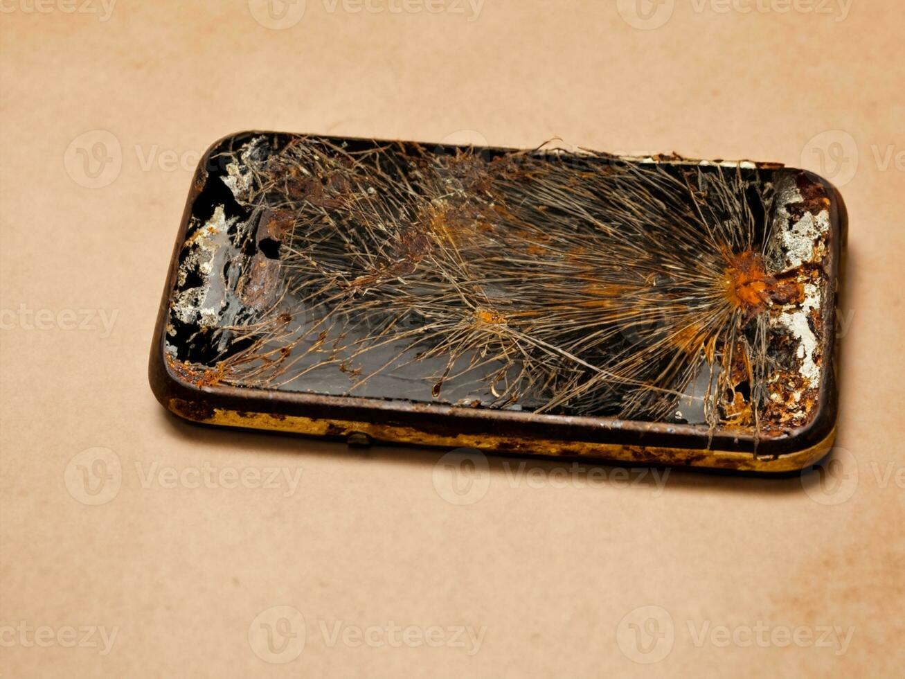 burnt smartphone on a wooden background photo