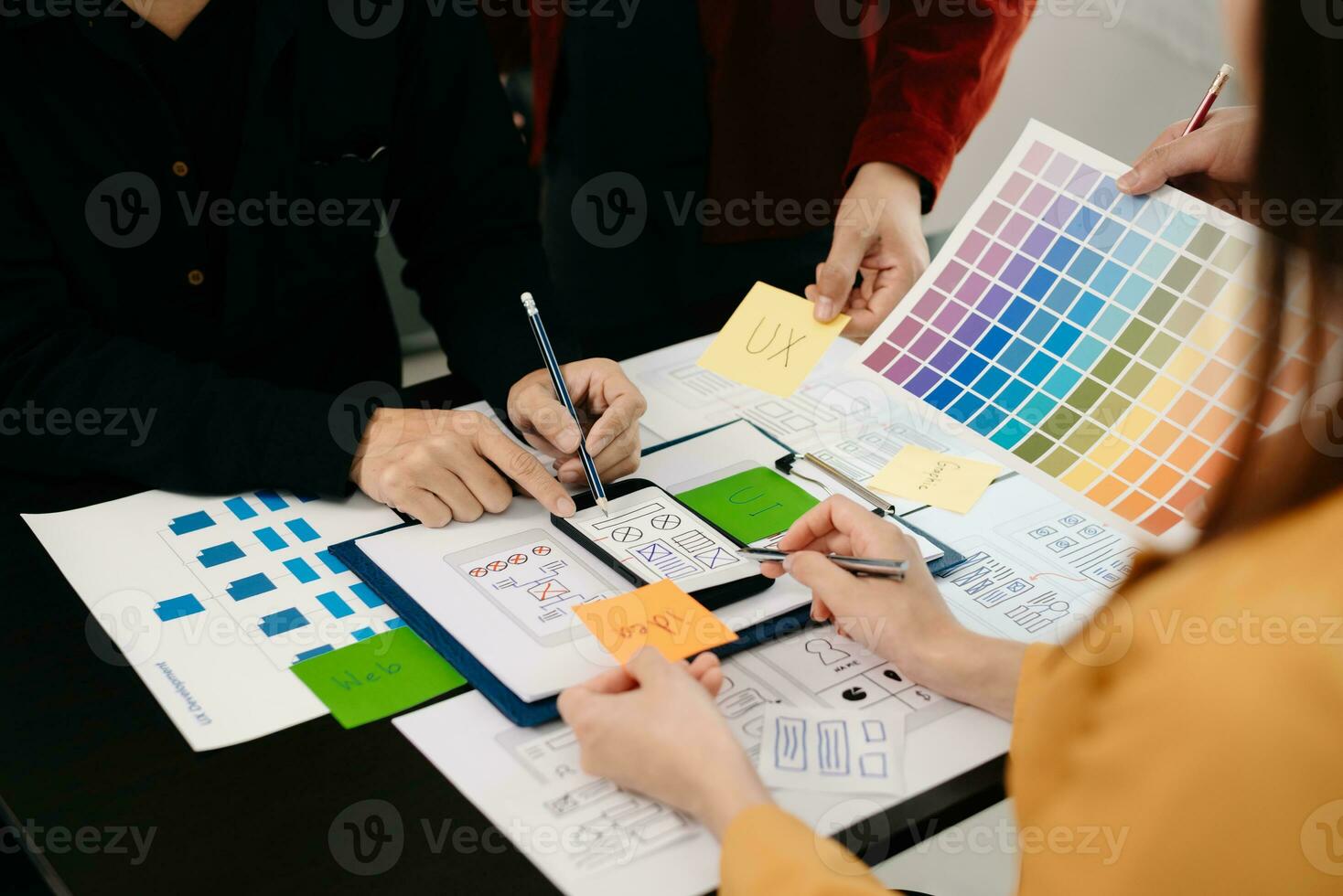 UX developer and ui designer brainstorming about mobile app interface wireframe design with customer breif and color code at modern office. photo