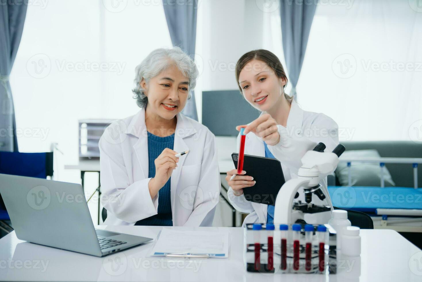 team Female scientist researcher conducting an experiment working in the chemical laboratory photo