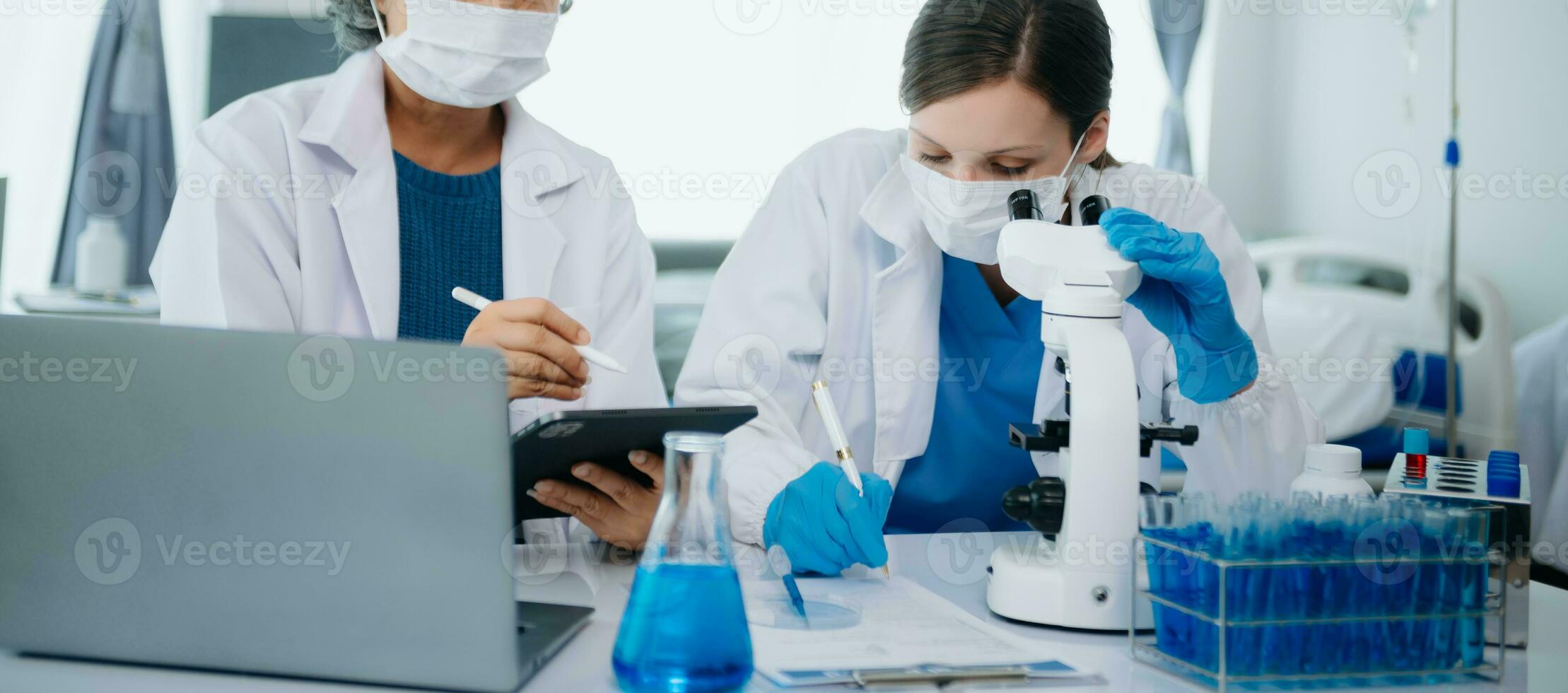 team Female scientist researcher conducting an experiment working in the chemical laboratory photo