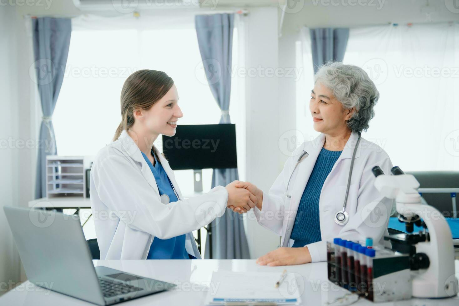 Hospital Ward. Doctor Talks With Professional Head Nurse or Surgeon, They Use Digital tablet Computer. Diverse Team of Health Care Specialists Discussing Test Result photo