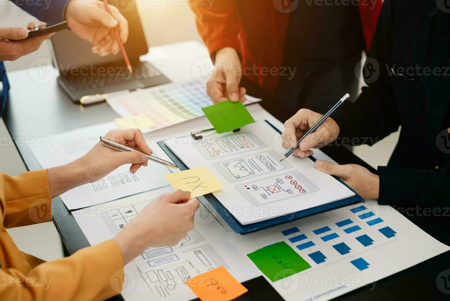 UX developer and ui designer brainstorming about mobile app interface wireframe design with customer breif and color code at modern office. photo