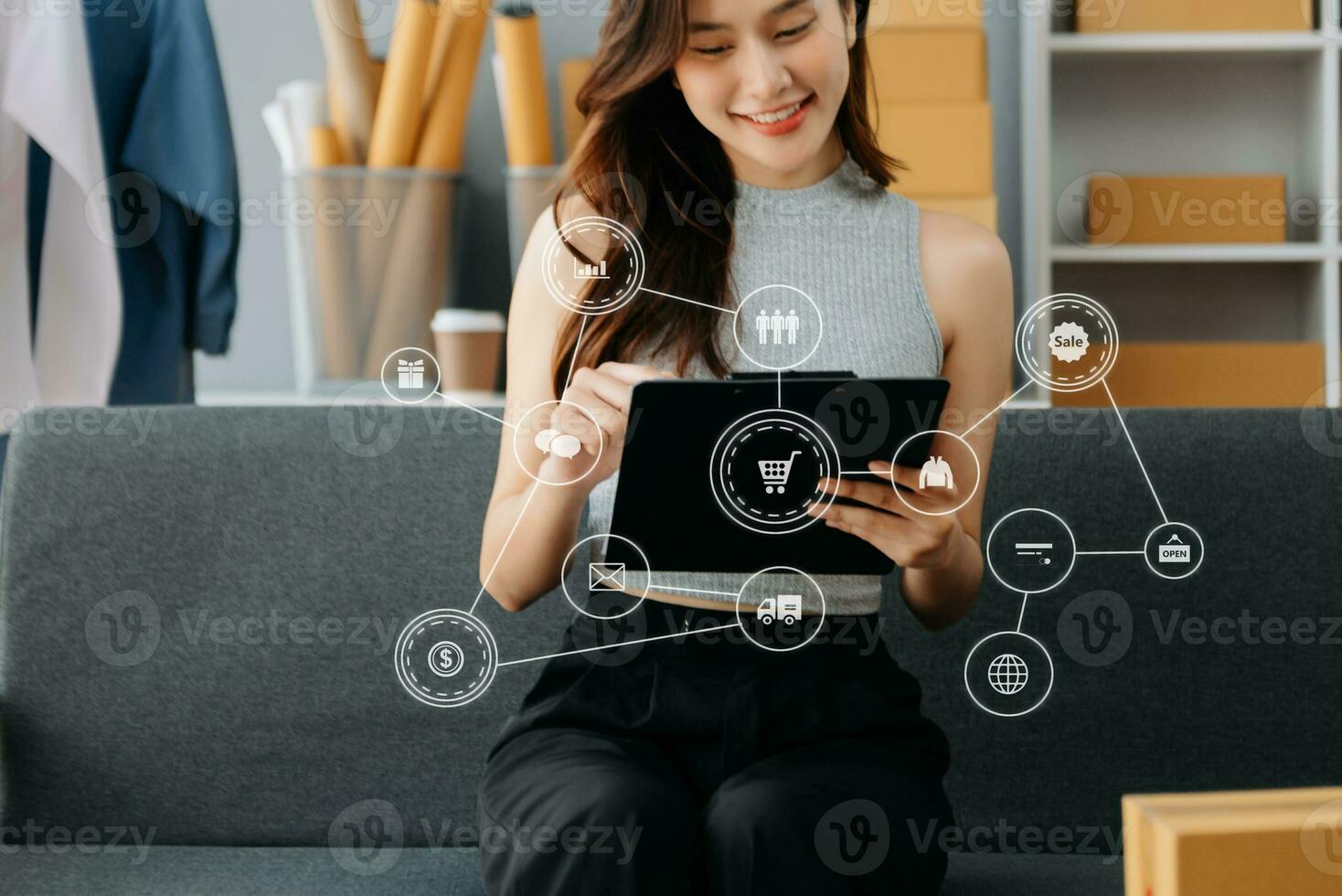 Young woman running online store Startup small business SME, using smartphone or tablet taking receive and checking online purchase shopping photo