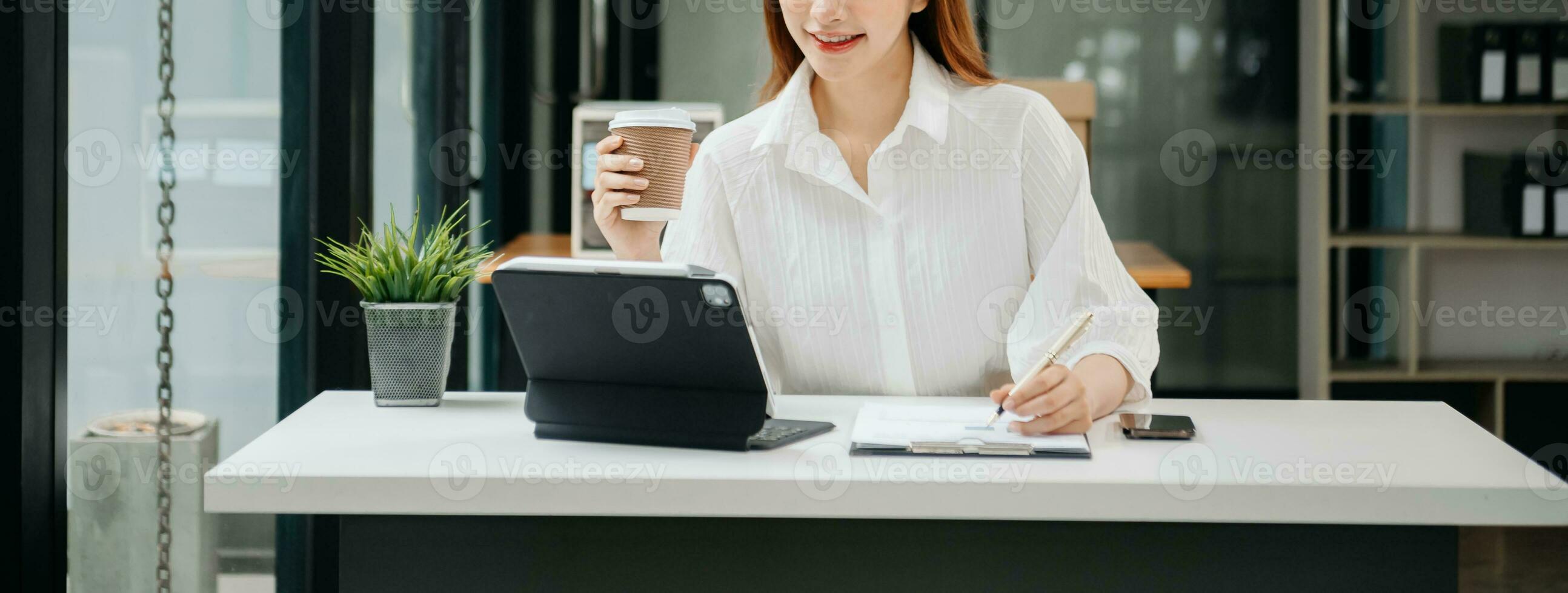 Woman hand using laptop, tablet and smartphone in office. Digital marketing media mobile app and discussing plan new start up project. Finance task. photo