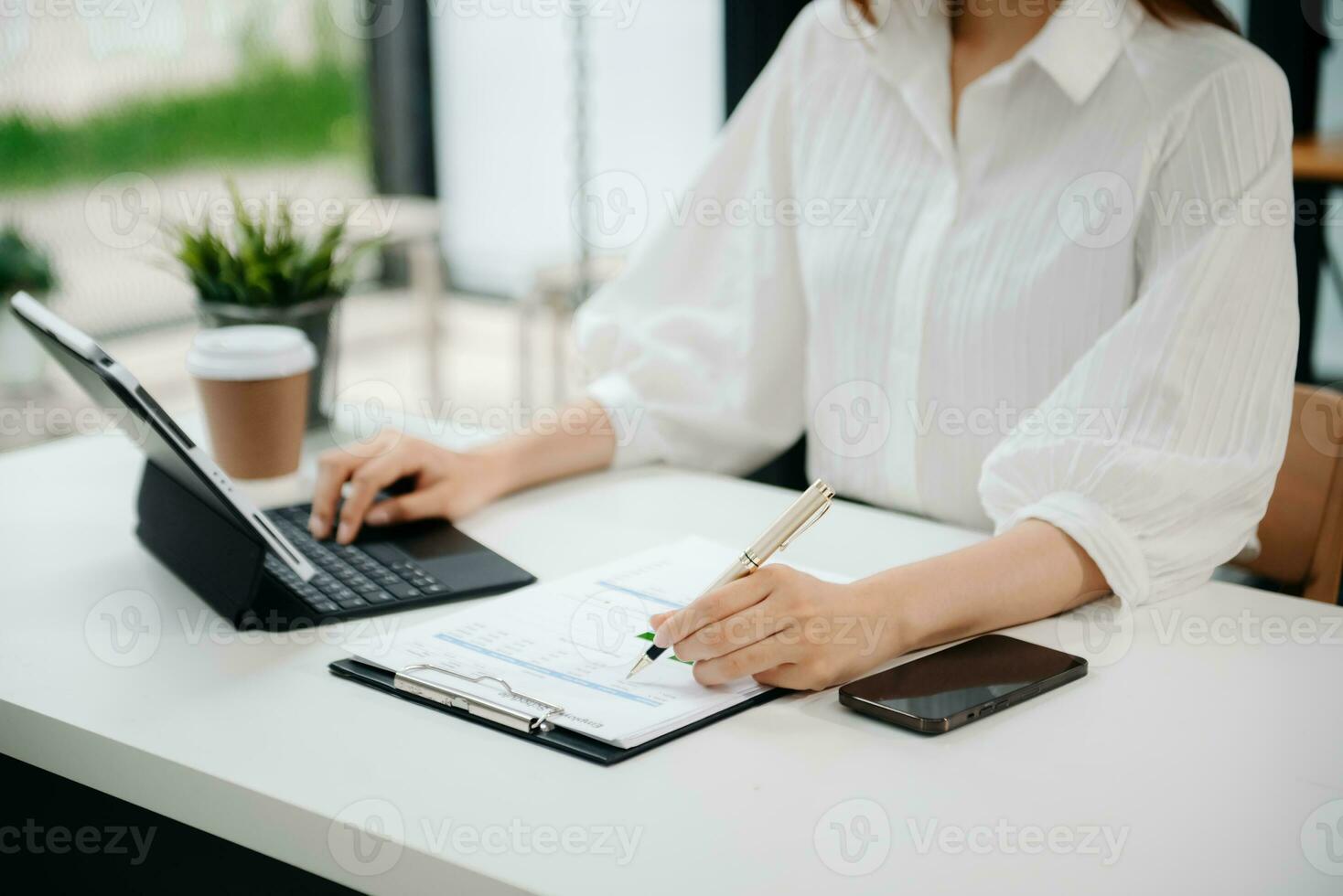 Woman hand using laptop, tablet and smartphone in office. Digital marketing media mobile app and discussing plan new start up project. Finance task. photo