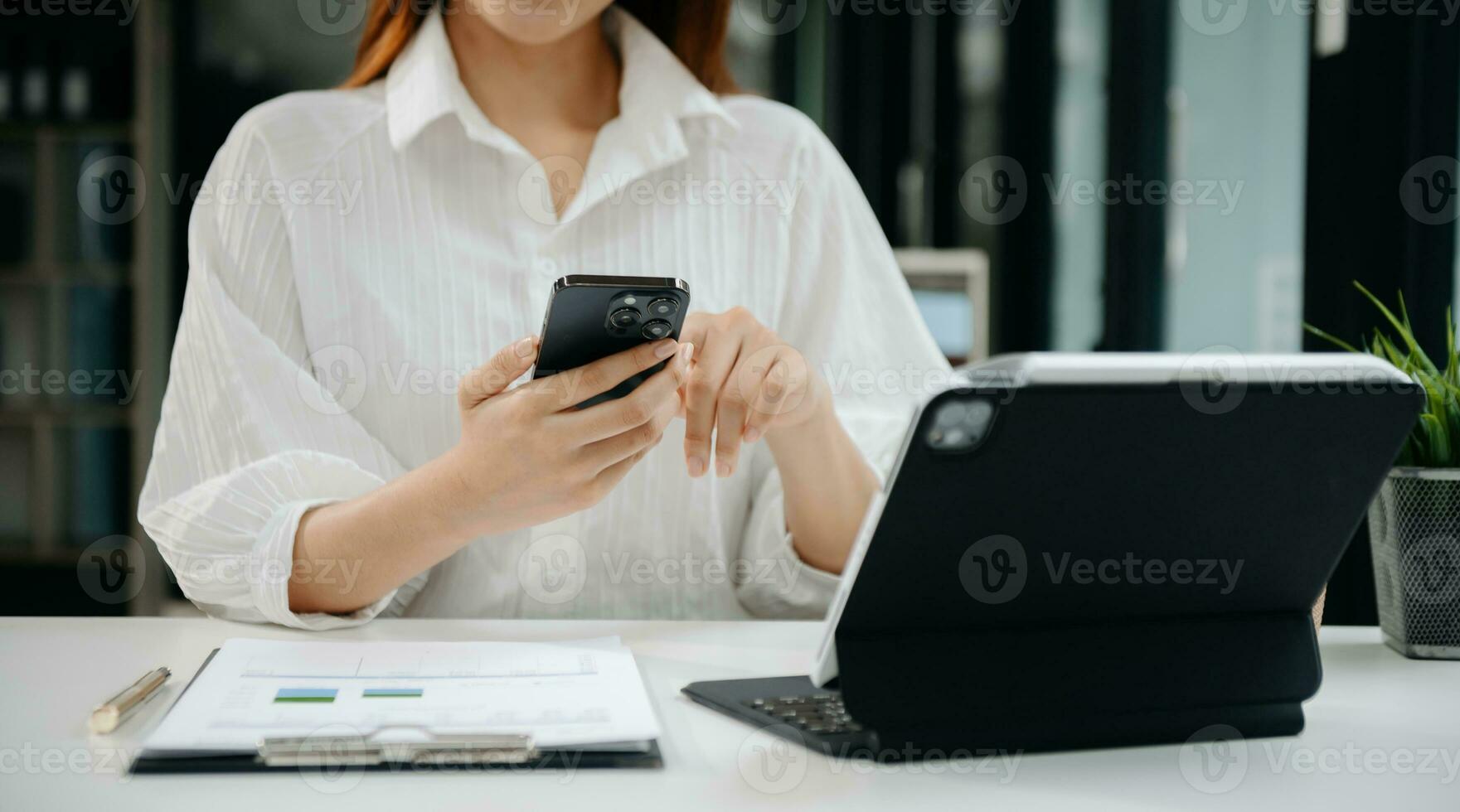 Woman hand using laptop, tablet and smartphone in office. Digital marketing media mobile app and discussing plan new start up project. Finance task. photo