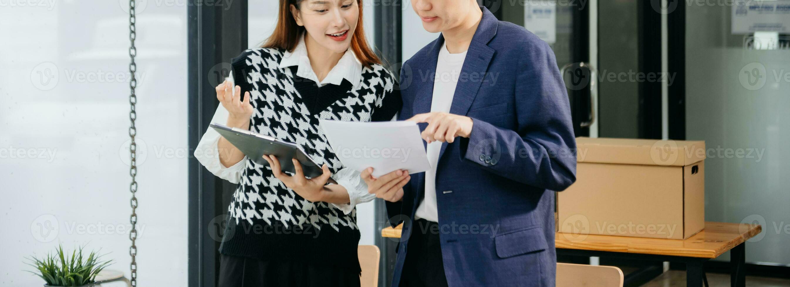 Kind leader executive manager share and discuss business solutions plan ideas on tablet with Asian female marketing manager in modern office. photo