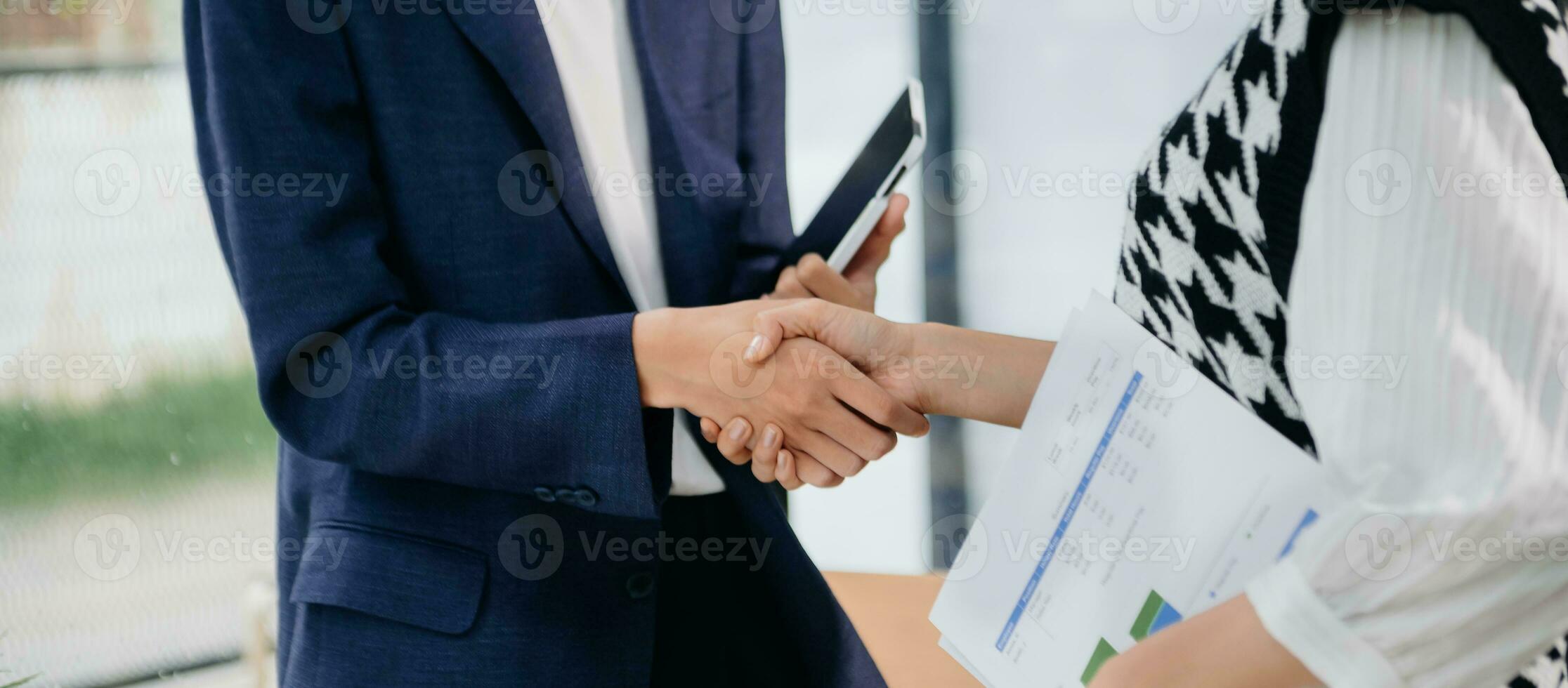 Two confident business man shaking hands during a meeting in the office, success, dealing, greeting and partner in sun light photo
