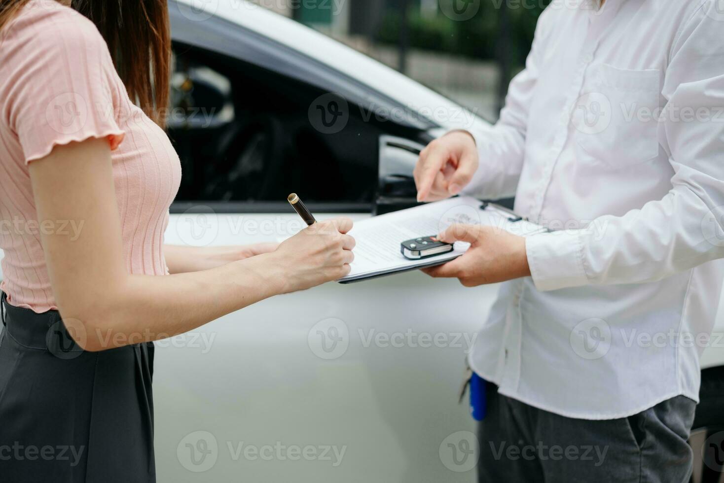 Automotive business, car sale or rental concept Customer with car dealer agent making deal and signing on agreement document contract in auto showroom or on road photo