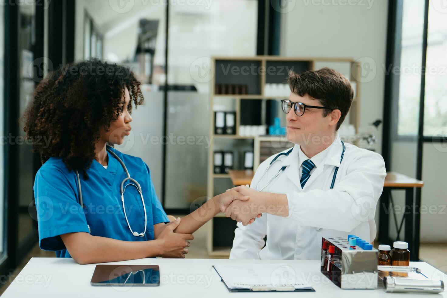 Doctor handshake and partnership in healthcare, medicine or trust for collaboration, unity or support.Team of medical experts shaking hands in teamwork for or success in clinic or hospital photo