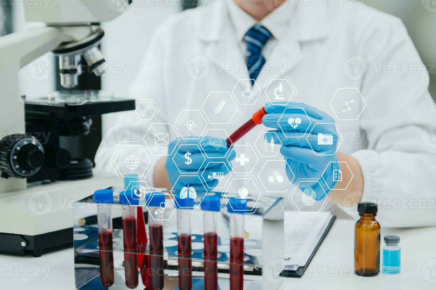 Mature scientists conducting research investigations in a medical laboratory, a researcher in the foreground is using a microscope in laboratory for medicine. photo