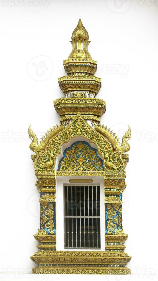 Carving of Thai Temple door in golden color photo