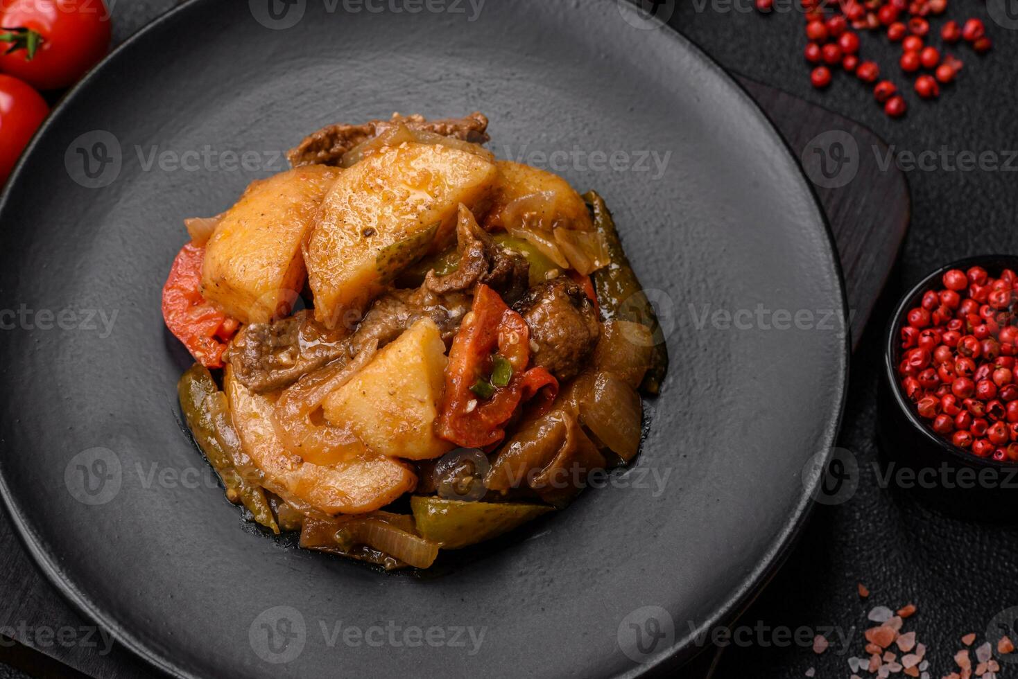 Delicious fresh stew of potatoes, tomatoes, onions, carrots and beef photo