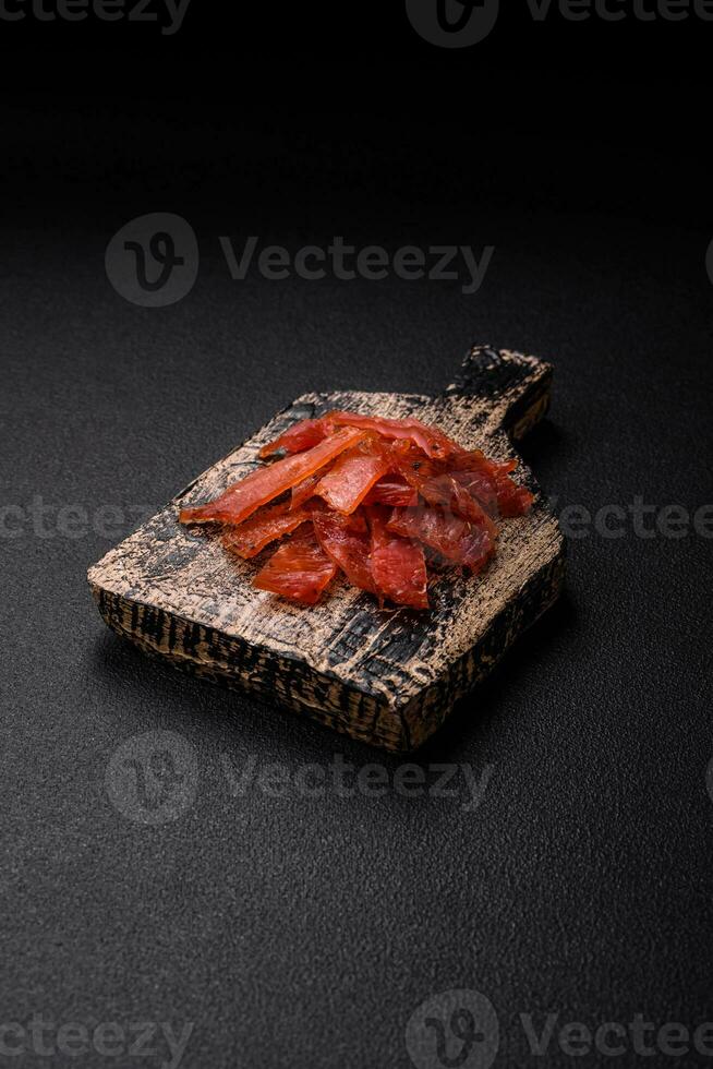 Delicious dried veal or turkey jerky with salt, spices and herbs photo