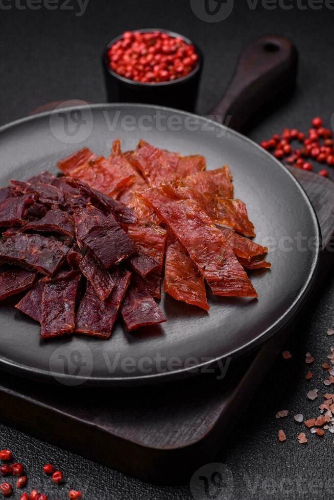 Delicious dried veal or turkey jerky with salt, spices and herbs photo