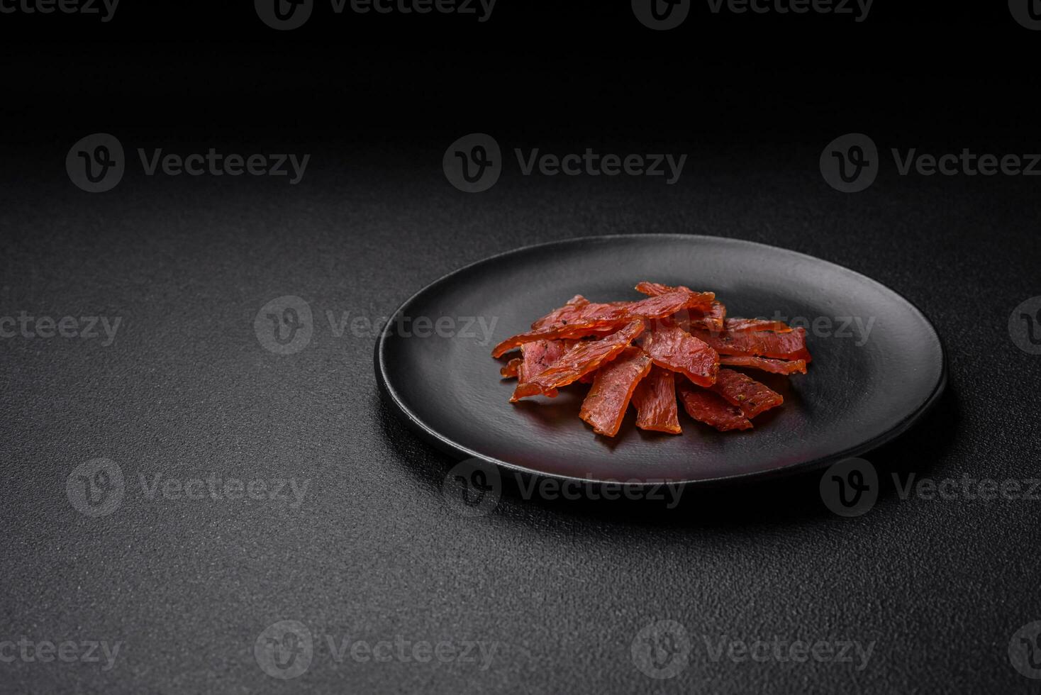 Delicious dried veal or turkey jerky with salt, spices and herbs photo