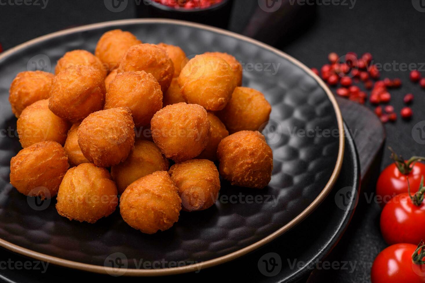 Delicious fried potato balls with breaded mozzarella, salt, spices and herbs photo