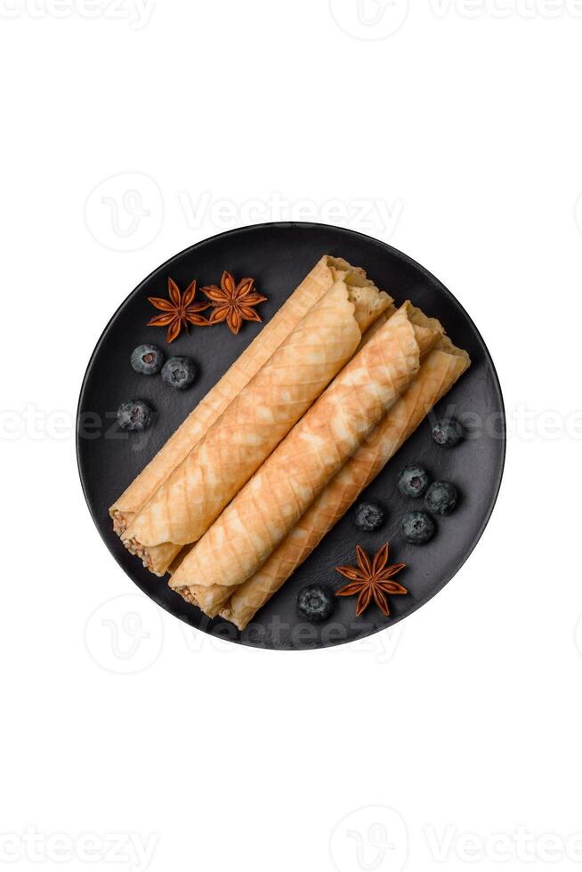 Delicious crispy wafer rolls with cream filling with nuts photo