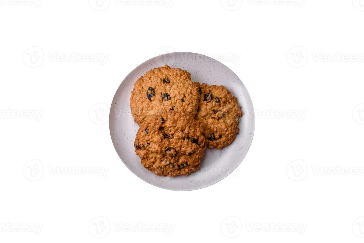 Delicious baked oatmeal raisin cookies on a dark concrete background photo