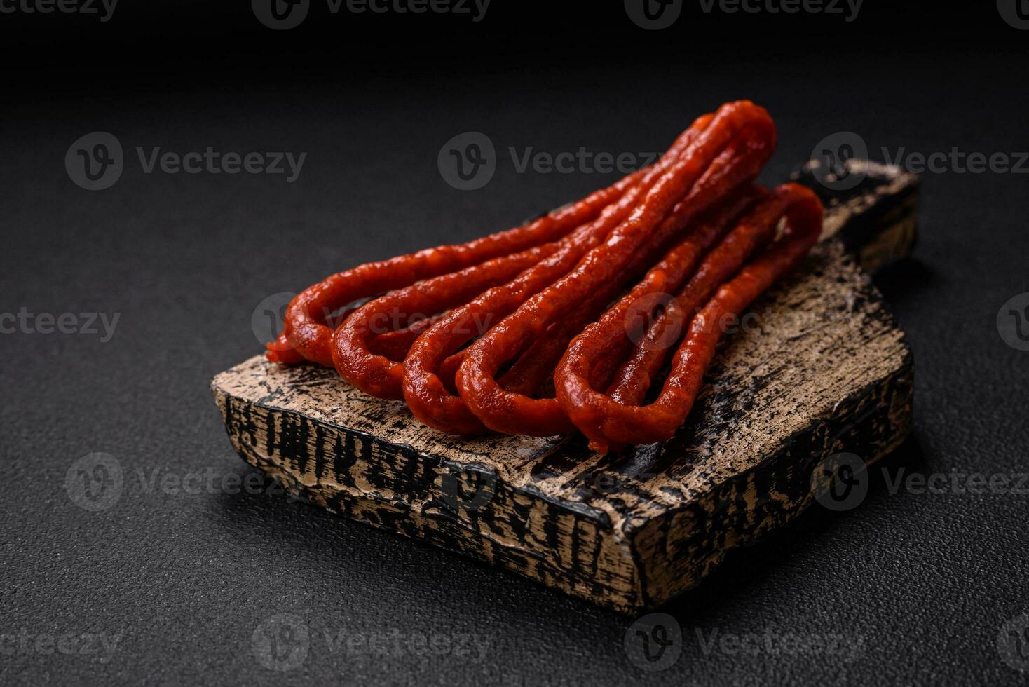 Delicious thin smoked hunting sausages with salt, spices and herbs photo