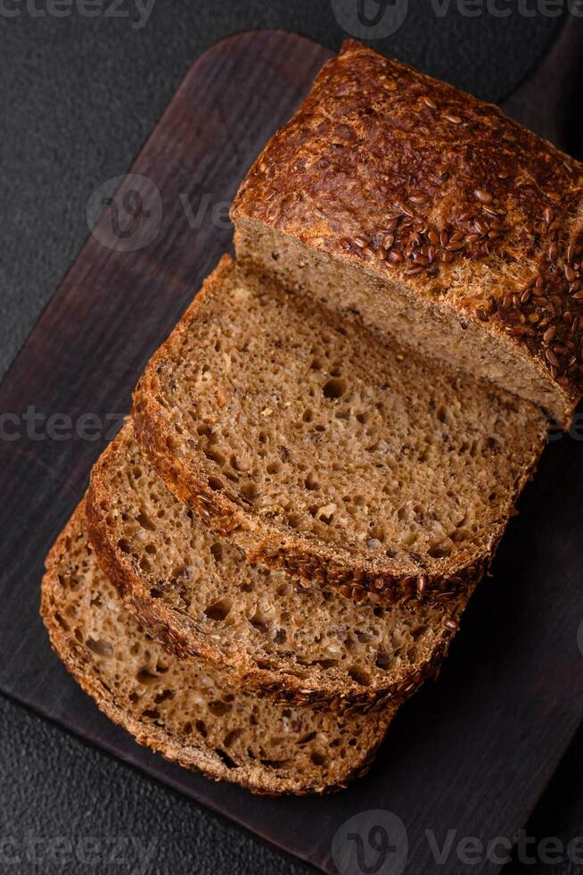 Delicious fresh crispy brown bread with grains and seeds photo