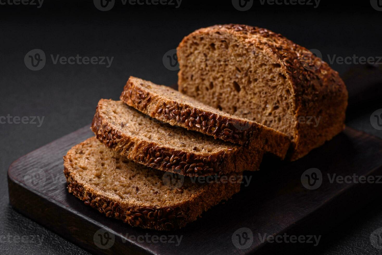 Delicious fresh crispy brown bread with grains and seeds photo